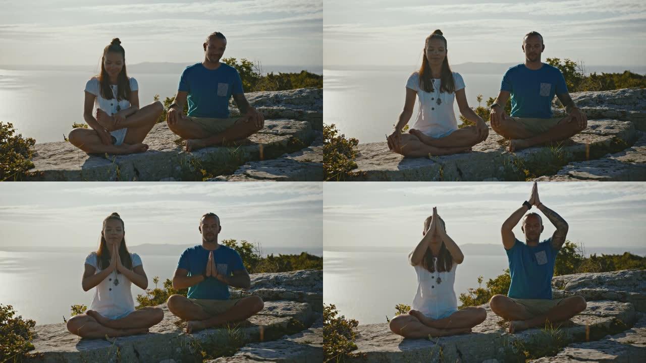 年轻夫妇在悬崖上的莲花姿势冥想瑜伽