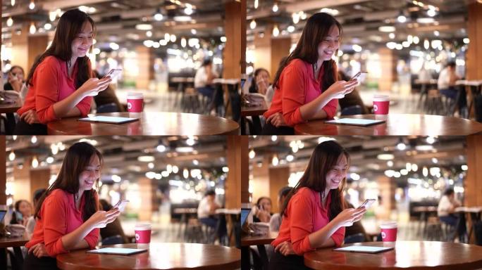 亚洲女商人在咖啡馆使用智能设备