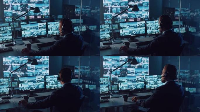 男警官在港口监控中心的一台带有监控闭路电视录像的计算机上工作，该中心在大屏幕上有多个摄像头。员工坐在