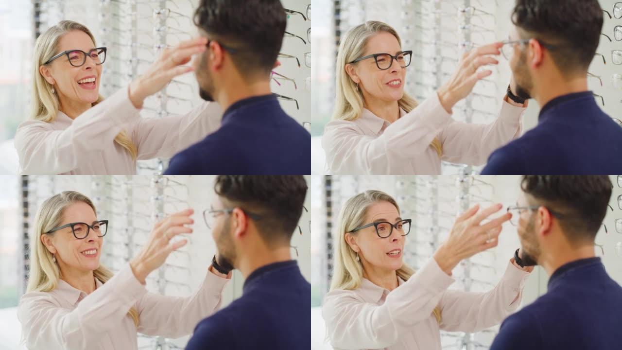 配镜师在验光期间帮助客户选择眼镜。男性顾客咨询验光师，配戴眼镜以矫正视力或改善视力