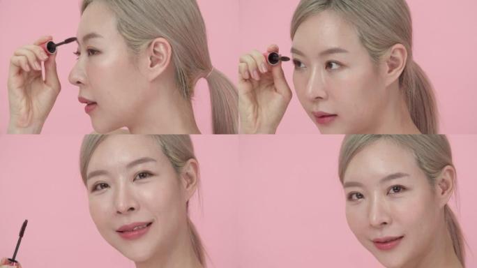 特写侧视亚洲女性为睫毛化妆涂睫毛膏的肖像。