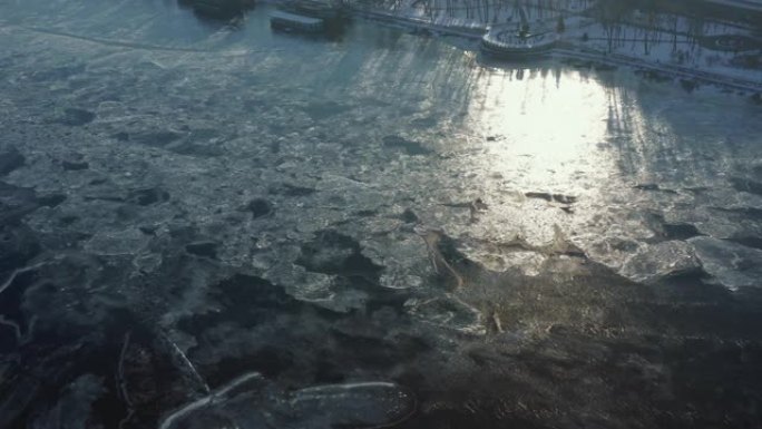 在寒冷的晴天，冬天在冰冻的第聂伯河上美丽的抽象冰雪图案的壮丽鸟瞰图。