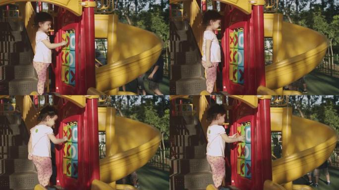亚洲蹒跚学步2岁的孩子喜欢夏天和她的祖父和祖母在公园里在户外玩玩具