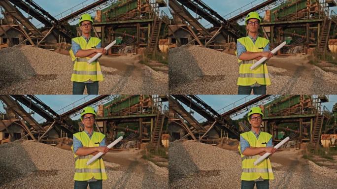 手持慢动作拍摄的男采矿工程师拿着蓝图图，背景中充满挖掘机的采矿坑
