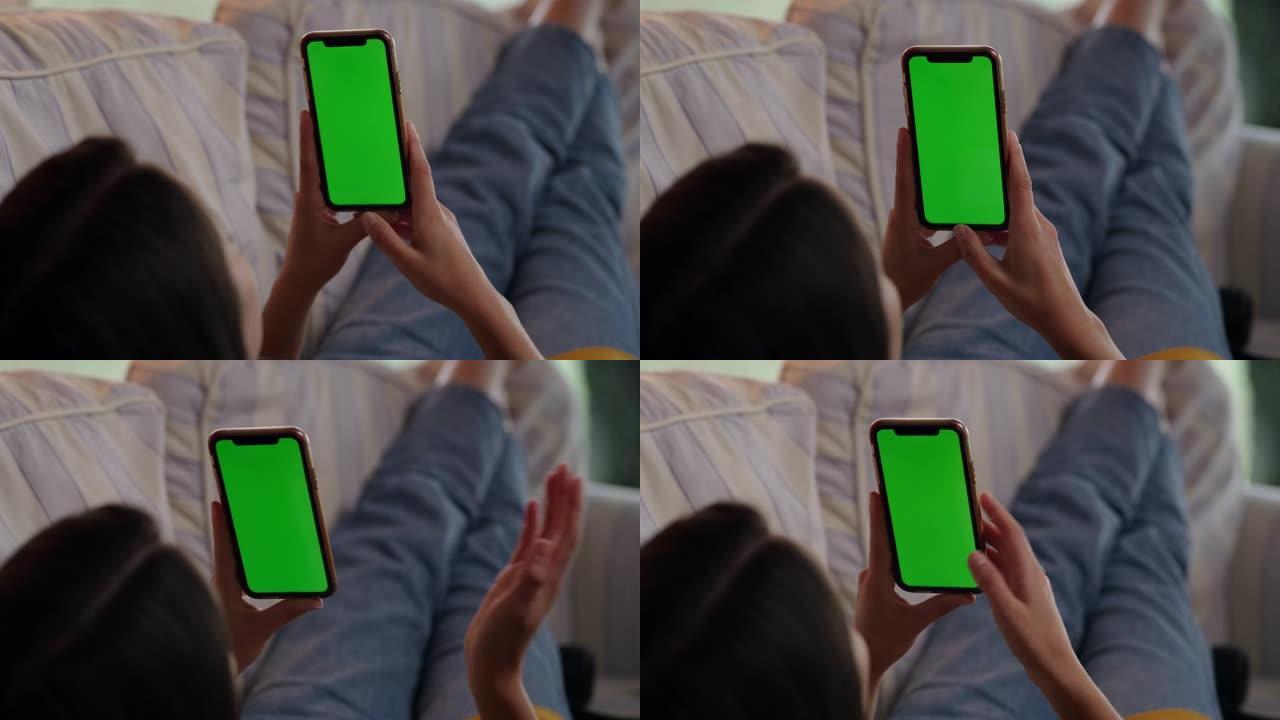 DS年轻女子在带有色度键绿屏的智能手机上进行视频通话