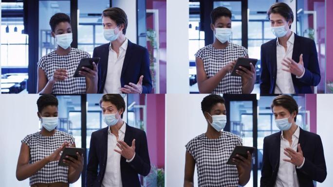 戴着口罩的多元化女企业家使用数字平板电脑在办公室里聊天