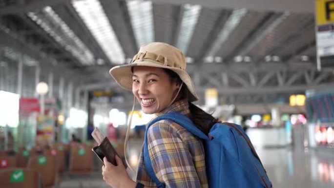 亚洲青年女子在候机楼机场门口行走慢动作