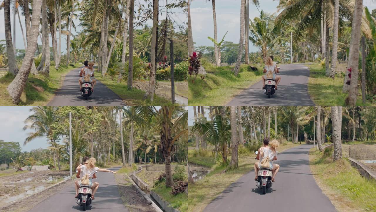 热带岛屿上骑摩托车的旅游夫妇快乐的女人举起双臂庆祝自由，享受与男朋友骑摩托车旅行的假期公路旅行