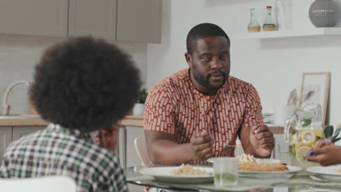 非裔美国男子在家与家人共进晚餐