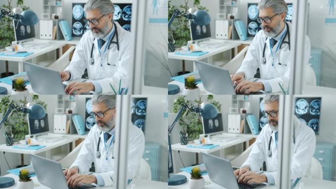 经验丰富的医生穿着白色长袍使用笔记本电脑打字专注于日常工作