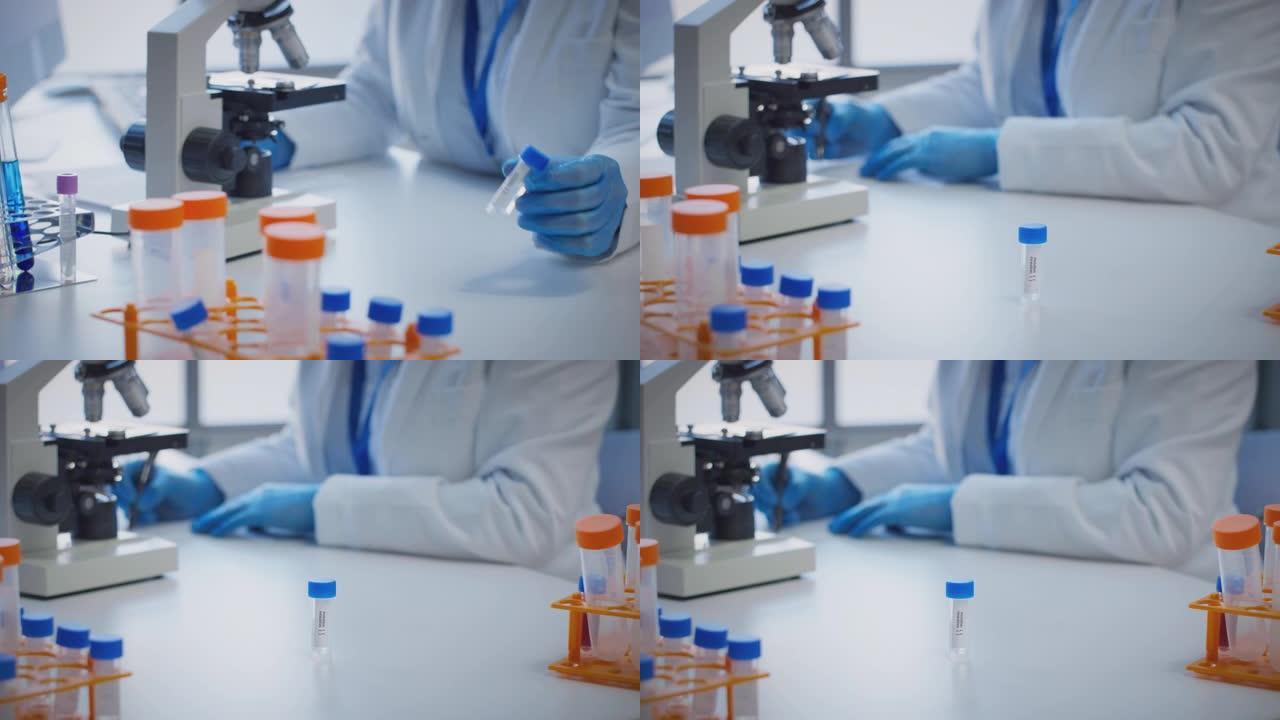 实验室工作人员使用显微镜进行研究，拿着标有阳性和阴性的试管