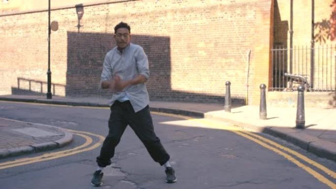 一个年轻人在城市背景下跳舞的4k视频片段