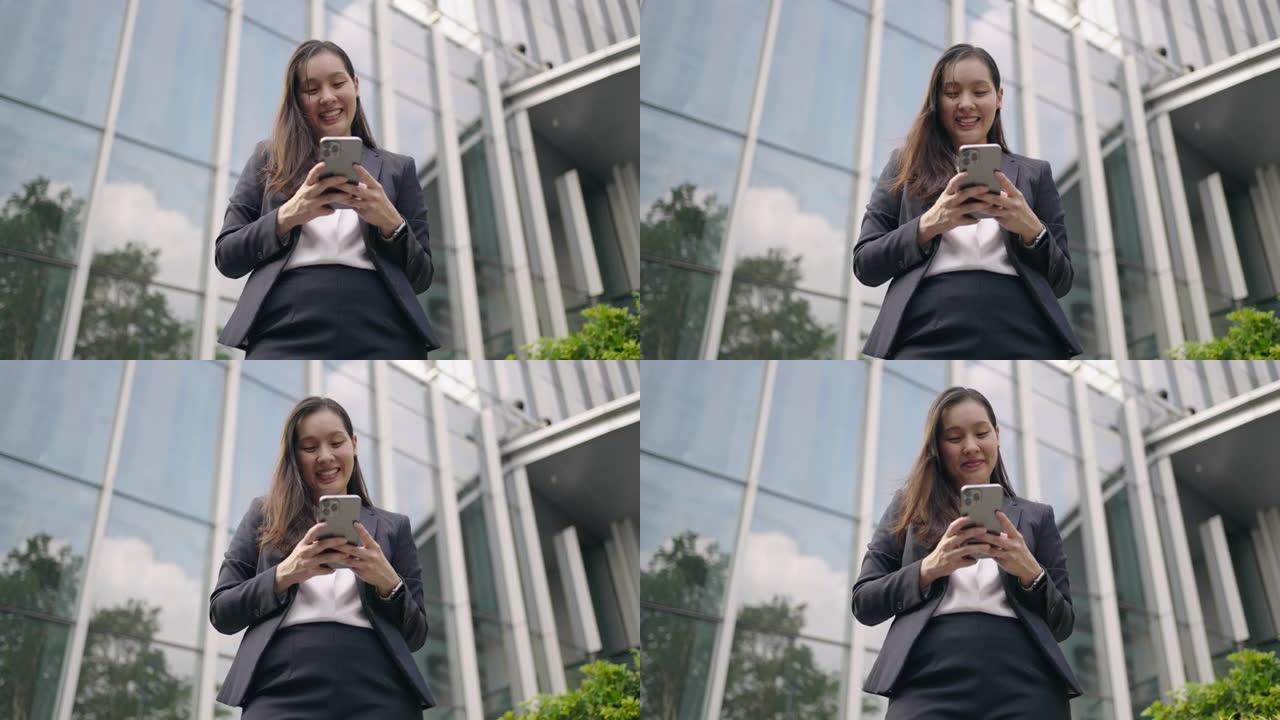 亚洲女商人在智能手机上发短信