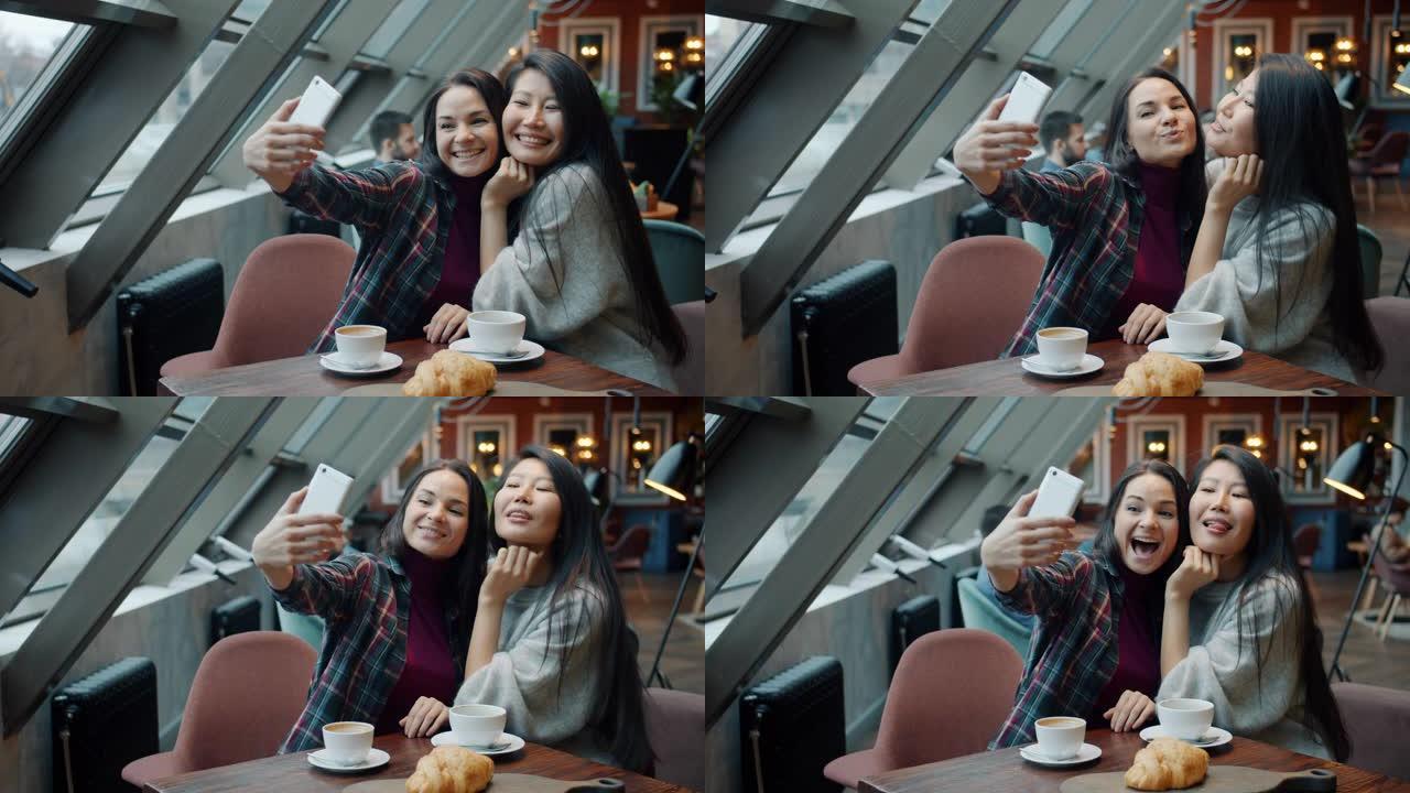 快乐的年轻女性在现代咖啡馆为智能手机相机拍照