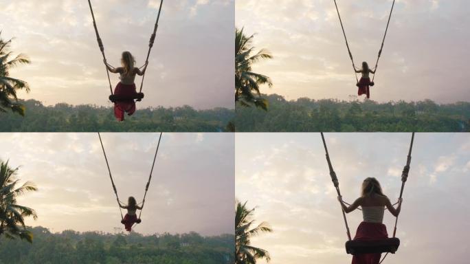 慢动作女人在日出时在丛林中摇摆旅行女孩享受热带雨林度假生活方式自由4k