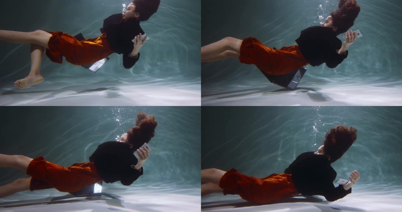 电影的侧视图，年轻的女商人沉入水下，智能手机，笔记本电脑慢动作。压力障碍概念