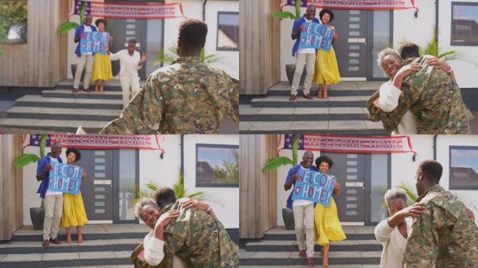 几代人的家庭，父母和妻子在房子外面用横幅和标语欢迎休假的军人回家，而他拥抱了母亲——慢动作拍摄