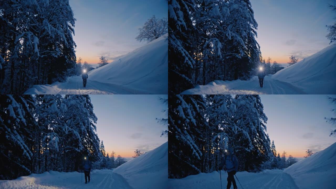 SLO MO徒步旅行者在积雪覆盖的乡间小路上行走时戴着头灯