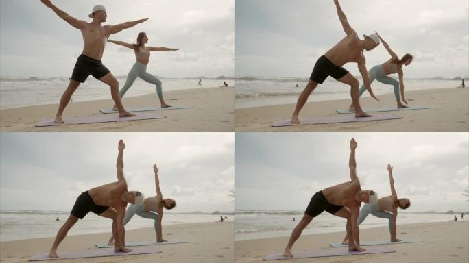 运动女人和男人在海滩上做瑜伽