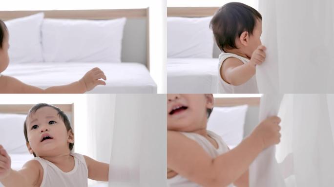 亚洲男婴玩捉迷藏与窗帘。迷人天真的亚洲婴儿。幸福的爱的家庭。家庭，生活方式，孩子，童年和父母观念，婴