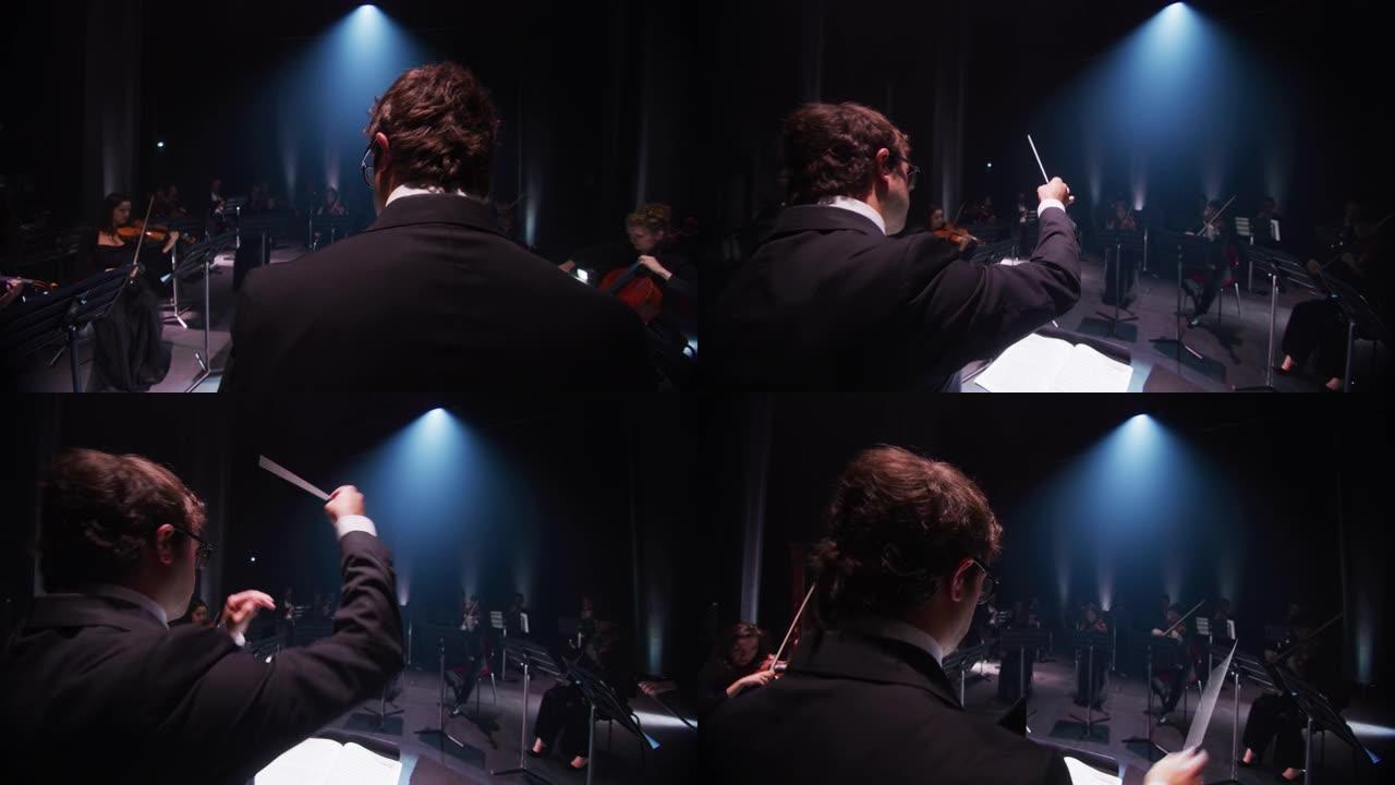 指挥交响乐团指挥的电影镜头，表演者戴着医用防护面具，在经典剧院演奏小提琴，大提琴和小号
