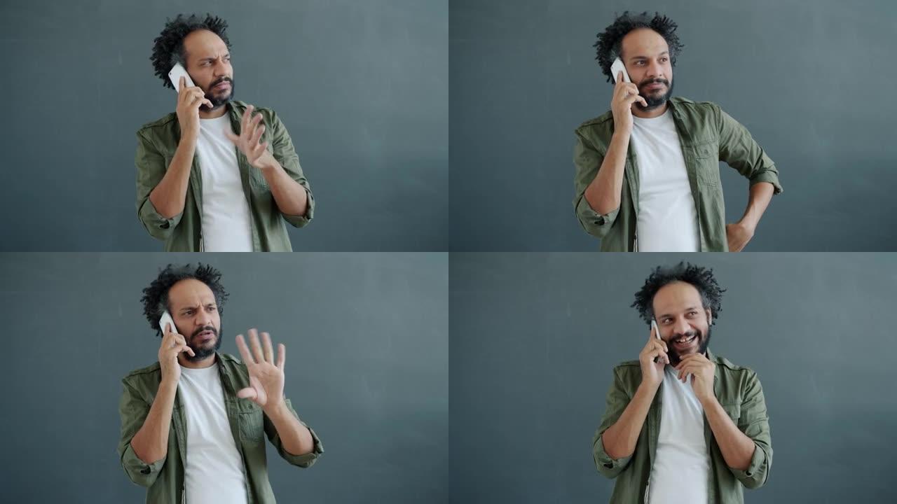 情感阿拉伯男子在手机上聊天的肖像表达了不同的情感