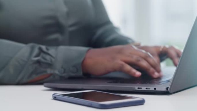 4k视频片段，一个无法识别的女人在现代办公室中使用手机和笔记本电脑