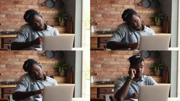 非洲商人在家中使用笔记本电脑进行电话交谈
