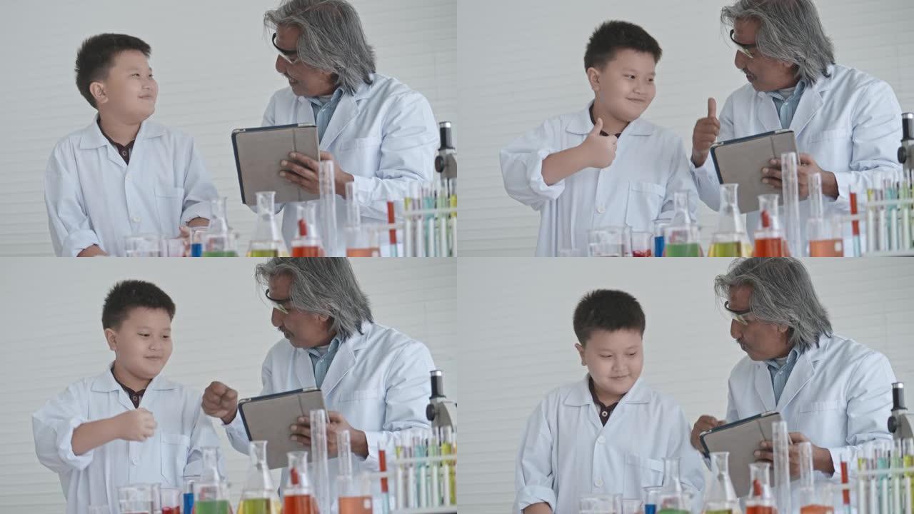 可爱的男孩与高级老师进行科学实验