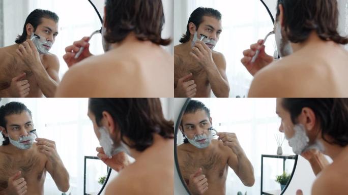好看的年轻人在浴室用剃刀刮脸的慢动作去除面部毛发