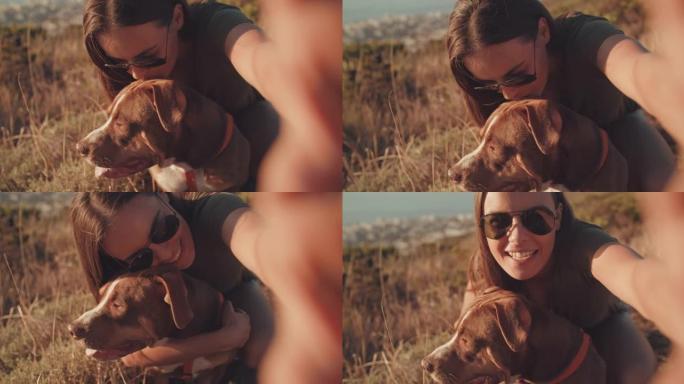 4k视频片段，一位迷人的年轻女子在与狗一起远足时自拍