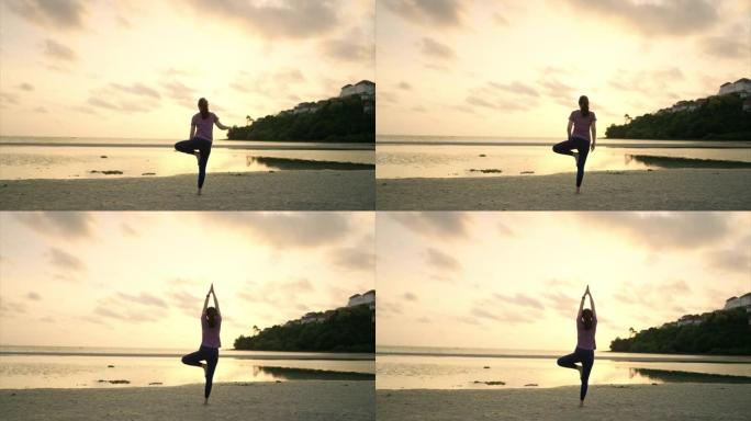 日落时练习瑜伽的亚洲女性