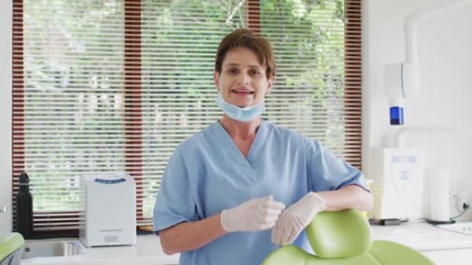 现代牙科诊所微笑的白人女性牙科护士的肖像