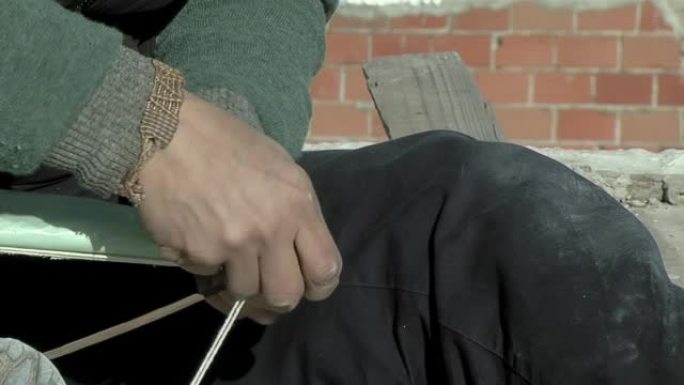 一个穷人的手用木箱手工制作风筝。特写。