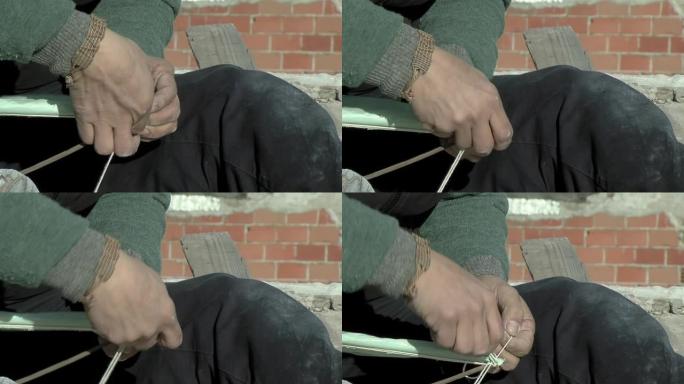 一个穷人的手用木箱手工制作风筝。特写。