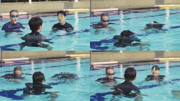 亚洲华人游泳教练在游泳池教他的学生呼吸锻炼
