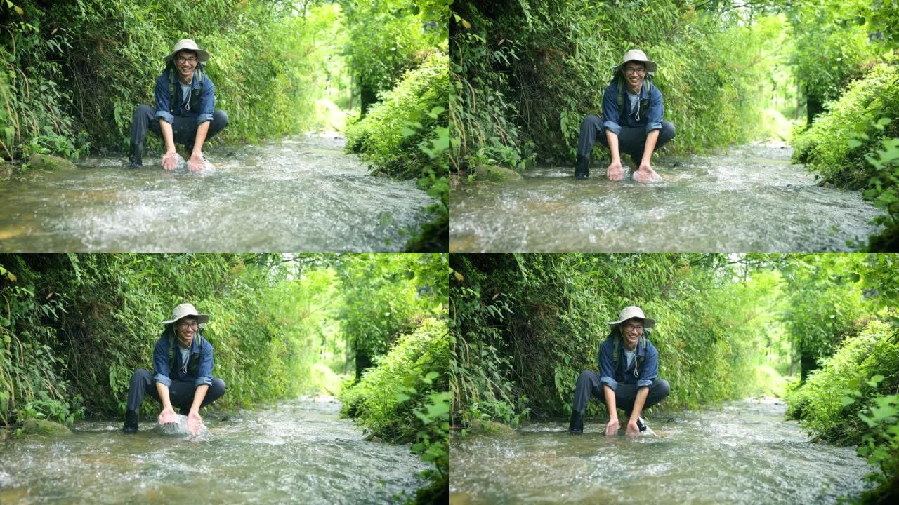 徒步旅行者在山间溪流中抽水