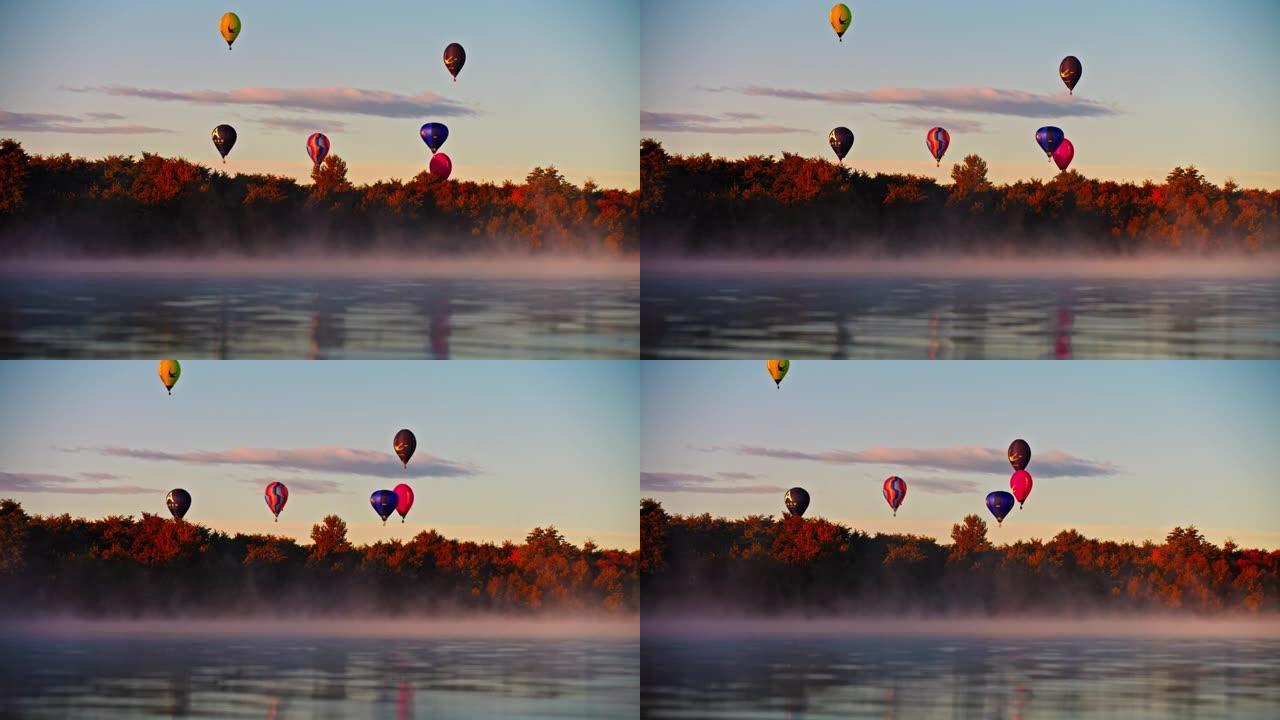 日出时，热气球飞越宁静的雾湖