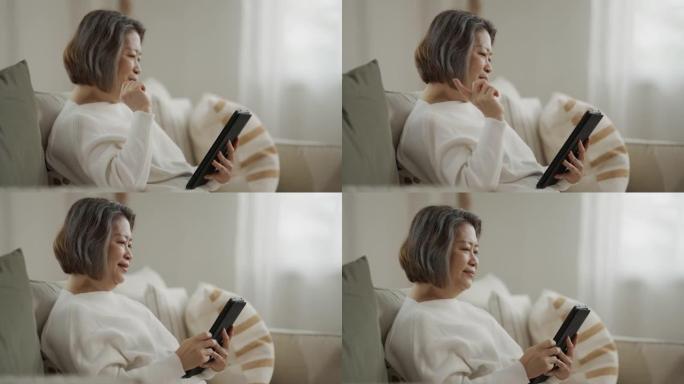 亚洲高级女性在家中通过数字平板电脑进行视频通话