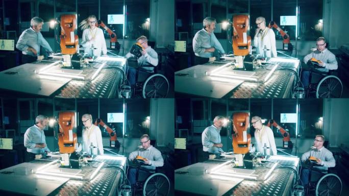 坐在轮椅上的男工程师和同事在现代实验室研究机器人