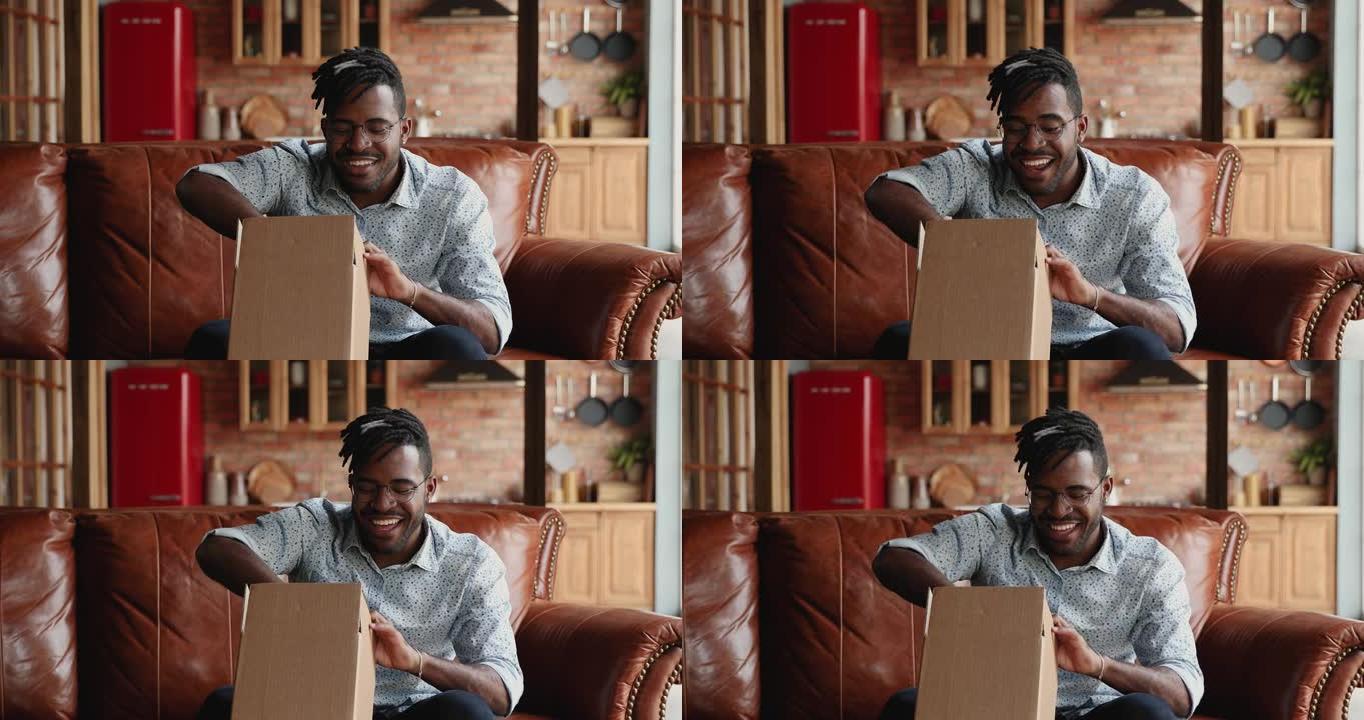 非洲男子用网上购买的优质商品打开包装箱