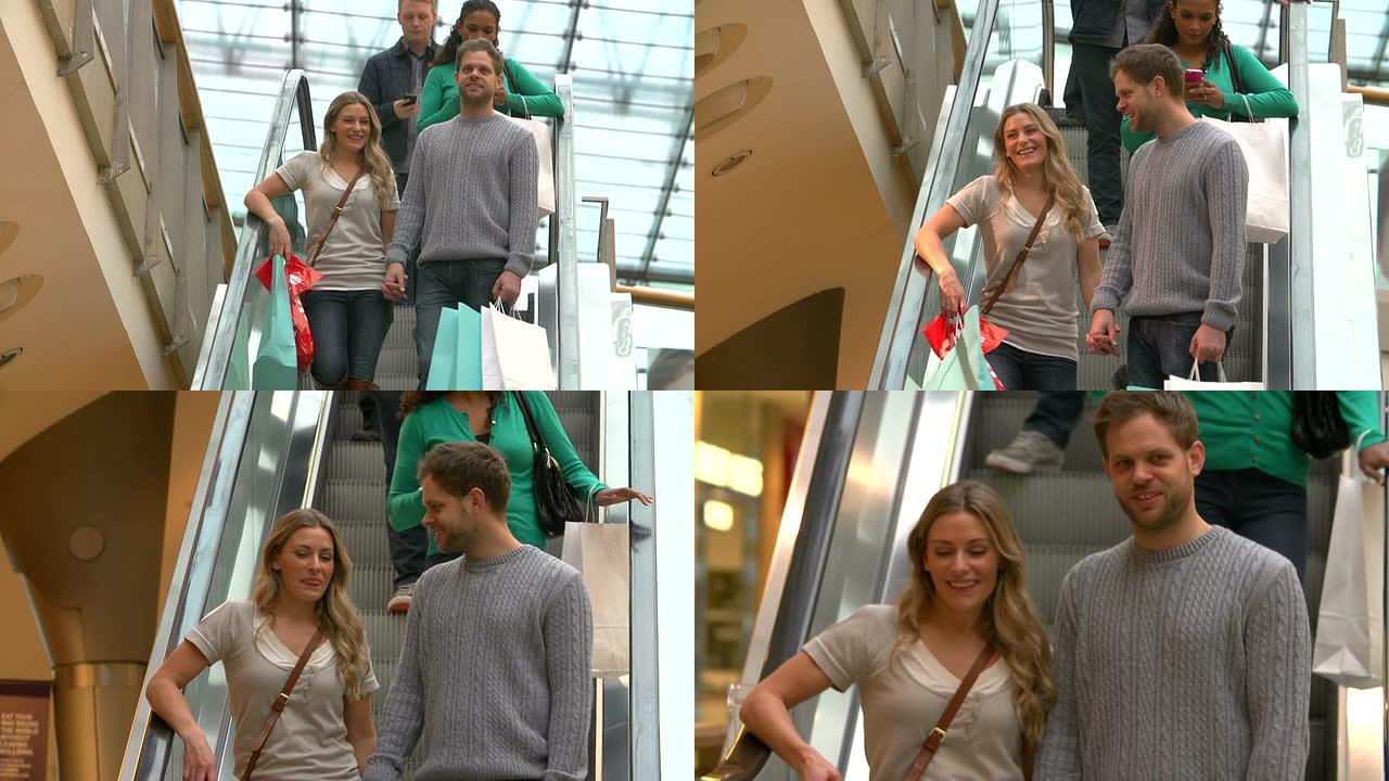 情侣一起在购物中心的自动扶梯上