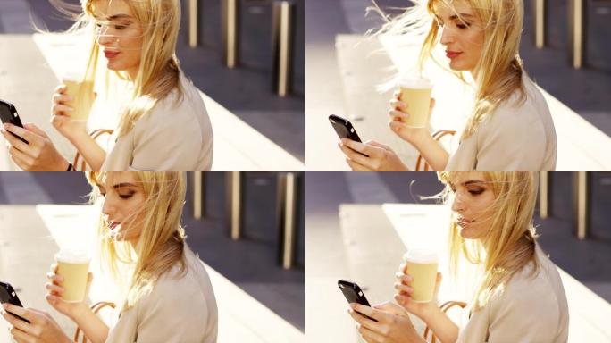 4k视频片段，一名年轻的女商人在使用手机时喝咖啡