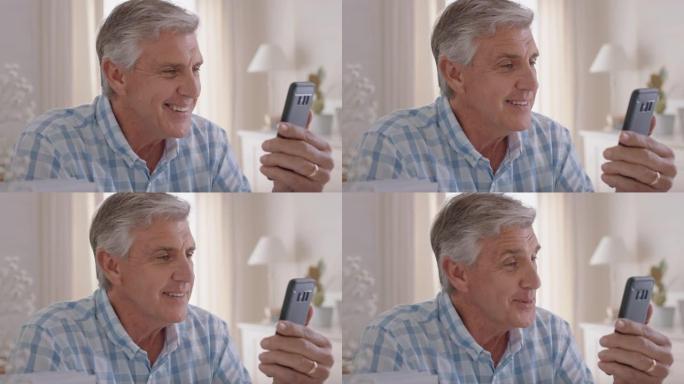 快乐的成熟男人使用智能手机进行视频聊天祖父享受与家人分享生活方式聊天手机在家放松4k