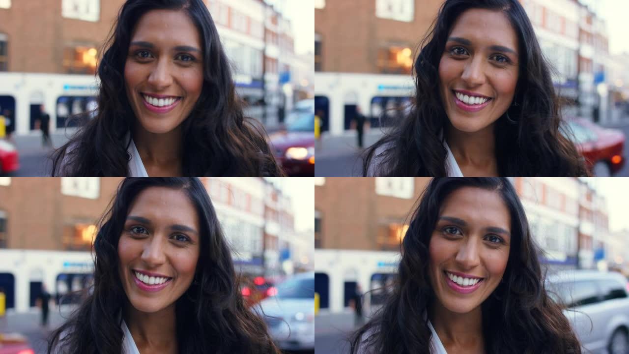 4k视频片段，一个美丽的年轻女子快乐地站在繁忙的街道上