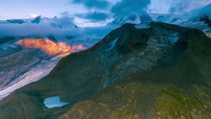 鸟瞰冰川上的日落，瑞士阿尔卑斯山冰川上的超流云景