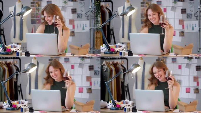 时尚企业的女老板，在工作室的笔记本电脑上播放一杯葡萄酒视频通话