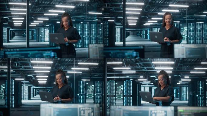 非裔美国女性IT专家的肖像使用笔记本电脑，站在数据中心。基础架构架构师在Web服务上工作。云计算、服
