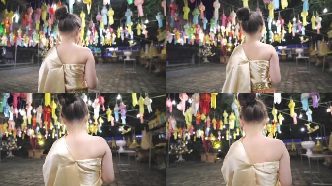 亚洲女孩穿着传统的泰国服装在灯笼传统