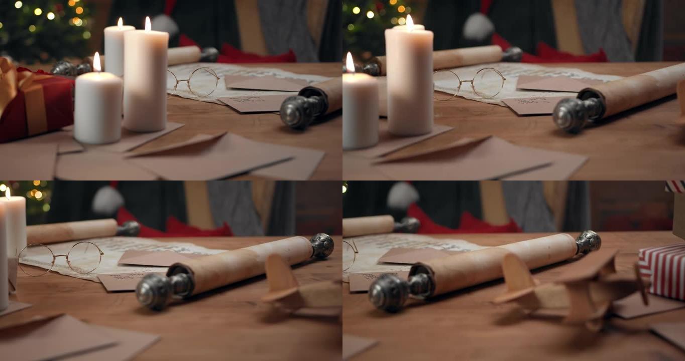 圣诞老人的桌子上有蜡烛，信封，带有儿童名字的卷轴，木制飞机和礼品盒